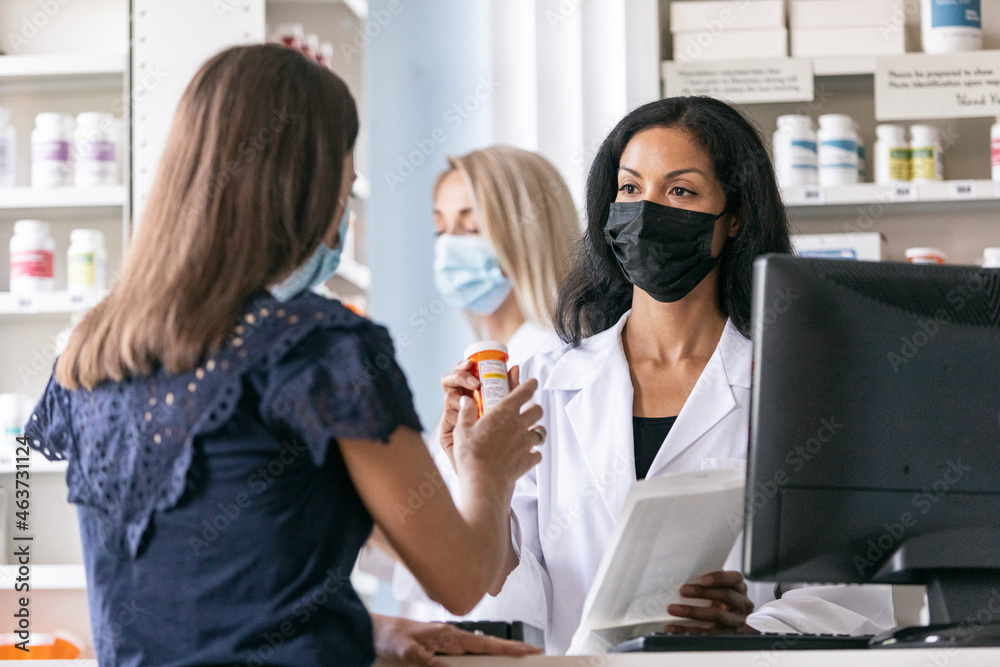 RX: Masked Pharmacist Helps Customer