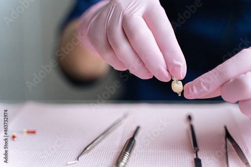 dentist with dental implant photo