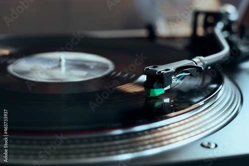 Vinyl record playing on turntable photo