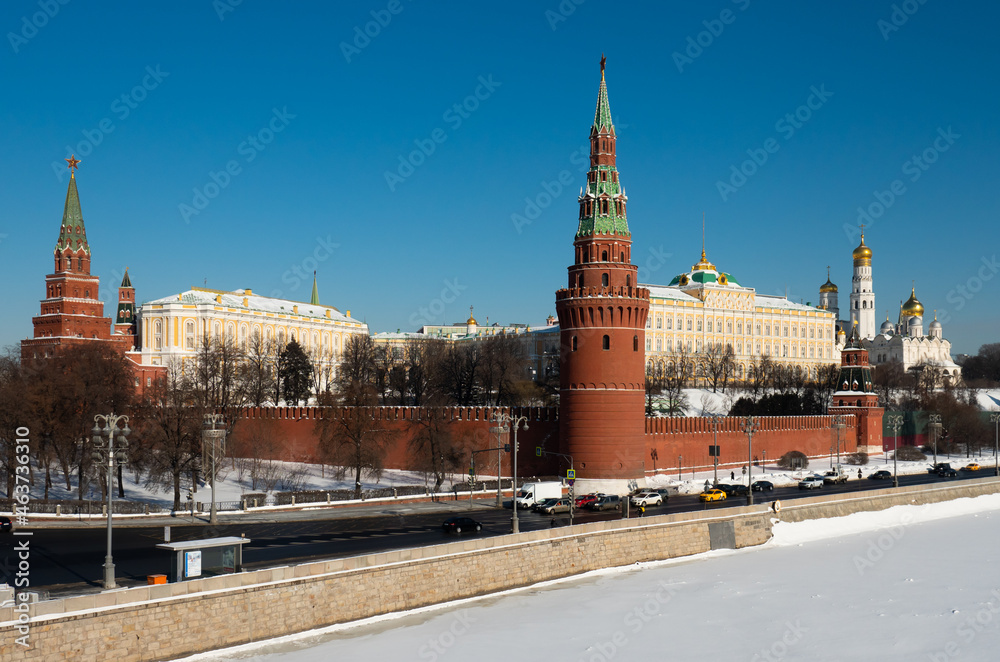 Daytime view of Moskow Kremlin, cathedrals and Moskva River in winter snowy weather, Russia