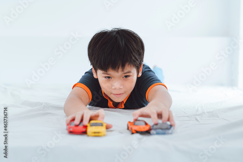 Boy plays with toy cars. photo