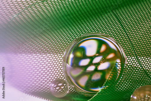 crystal ball in the green plastic nets with the reflection photo