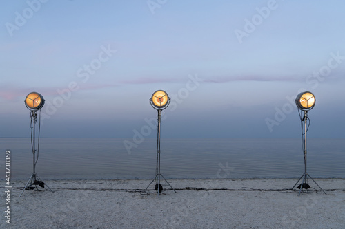 Lighting lamps on light stands at seashore photo