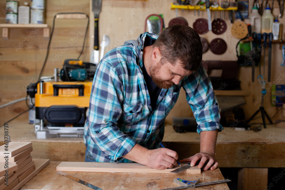 Joinery. workers. The carpenter measures with a ruler and draws with a pencil. Tree. Ecological compatibility. Lifestyle. Joinery. workers. The carpenter measures with a ruler and draws with a pencil. Tree. Ecological compatibility. Lifestyle.