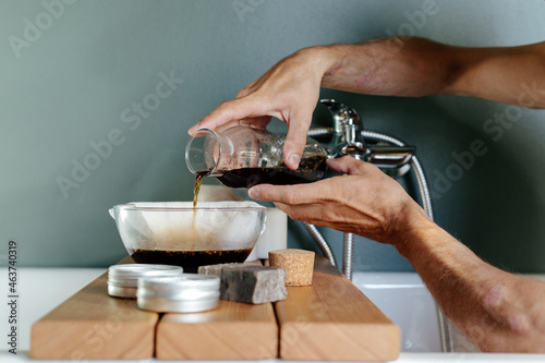 Crop man with psoriasis preparing herbal decoction  photo