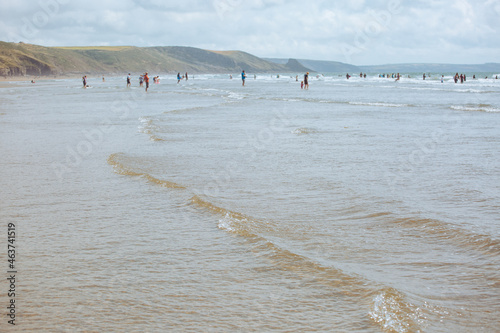 Distant figures on a vast beach photo