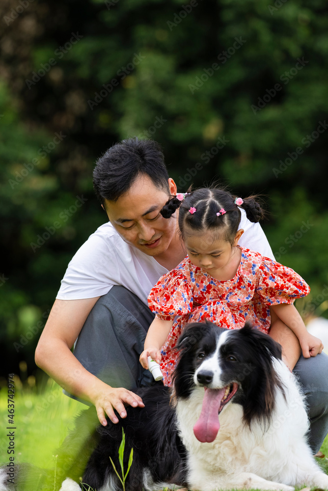 happy asian man with daughter and dog in the park happy asian man with daughter and dog in the park