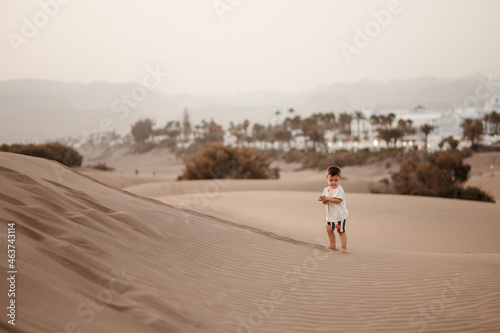 Cute toddler boy in sandscape. photo