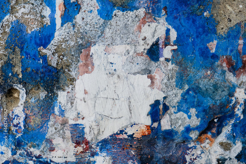 Crumbling Concrete Wall with White and Blue Paint  photo