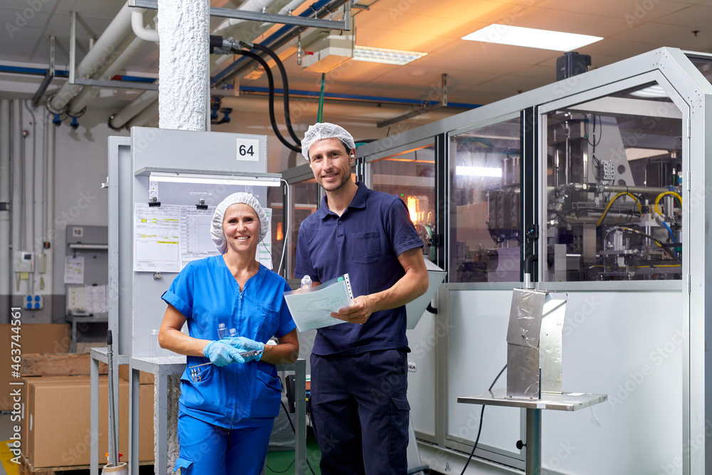 Happy factory workers looking at camera Happy factory workers looking at camera