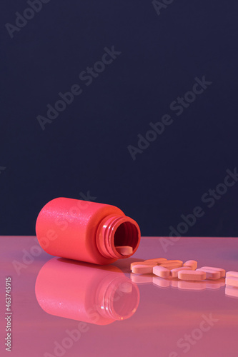 Pills spilling out of the bottle photo