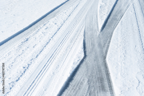 Outline of tyre tracks on snowy road photo