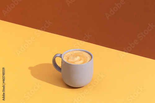 Cup of coffee on yellow table