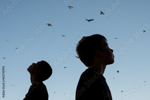 Two Boys Looking up into the sky in awe of nature photo