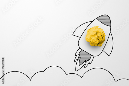 Fototapeta Naklejka Na Ścianę i Meble -  Rocket sketch drawing cartoon with crumpled paper ball on white background. Successful business startup. Creative thinking ideas and innovation concept