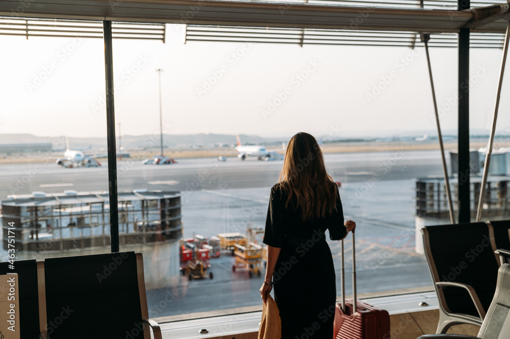 Woman with suitcase in airport Woman with suitcase in airport