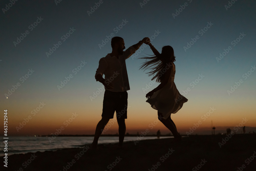 Silhouette of a couple dancing on the beach Stock Photo | Adobe Stock
