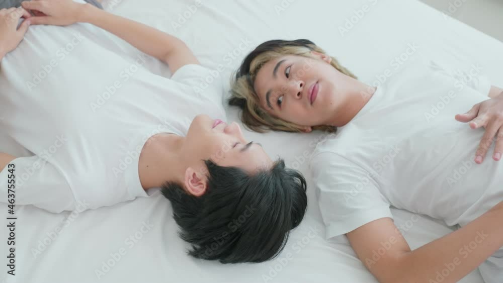 Asian young male gay family lying down on bed and look at each other. Asian young male gay family lying down on bed and look at each other.