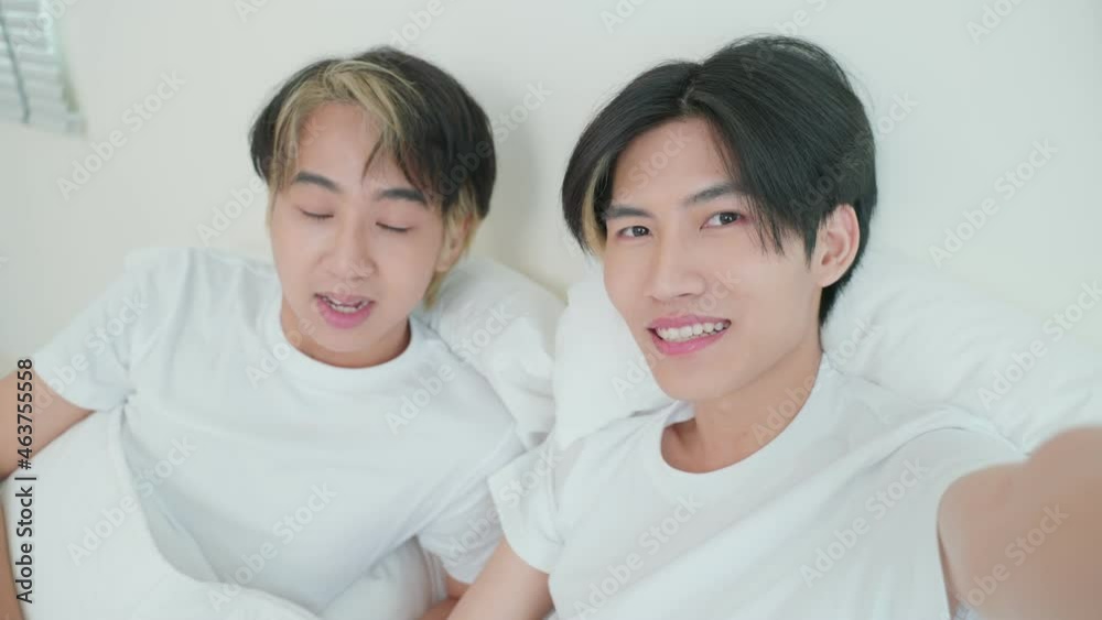 Asian handsome man gay use mobile phone video call online with family. Asian handsome man gay use mobile phone video call online with family.