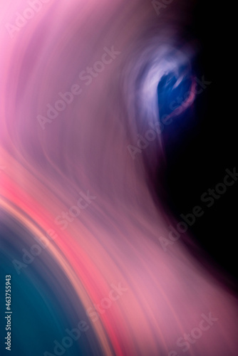A blue-eyed pink elephant. Motion blur close-up image of eye, nose, and forest. Fantasy animal creature with mysterious charm and cuteness.