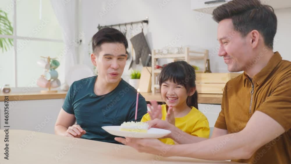 Asian attractive LGBTQ gay family celebrate birthday girl kid in house. Asian attractive LGBTQ gay family celebrate birthday girl kid in house.