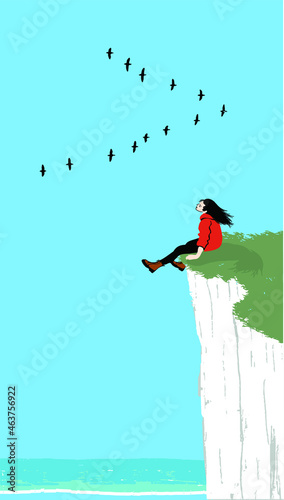 girl sitting on a high cliff on the coast and watching a flock of birds flying, the girl is wearing orange jacket, black tights and brown boots, a long cloud in the blue sky, white wave on the sea. © libera caballo