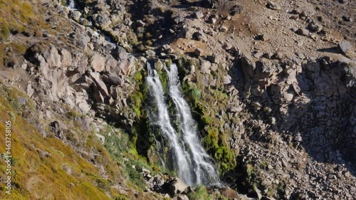 Picturesque waterfall on volcanic slope in Tongariro National Park photo