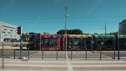 a colorful tram moving towards the city center, Montpellier - France photo