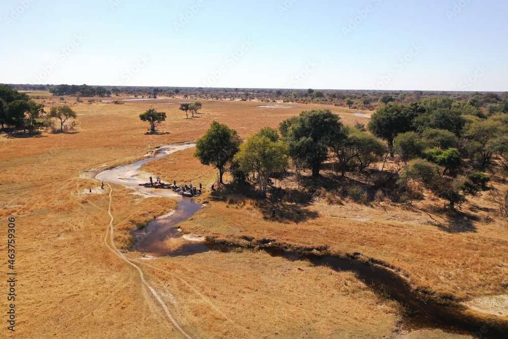 Camping expedition arrives to their campsite for the day near some shaded tree island near Gonutsoga village in the north west of Botswana, Africa