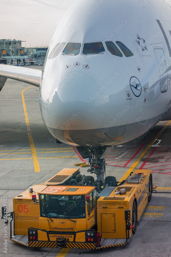 Airliner bush-back with a tug on the airport ภาพถ่ายสต็อก | Adobe Stock