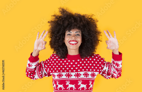 pretty latin hispanic woman, with christmas clothes, and ok gesture
