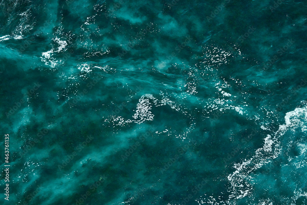 Fototapeta premium Aerial view to seething waves with foam. Waves of the sea meet each other during high tide and low tide