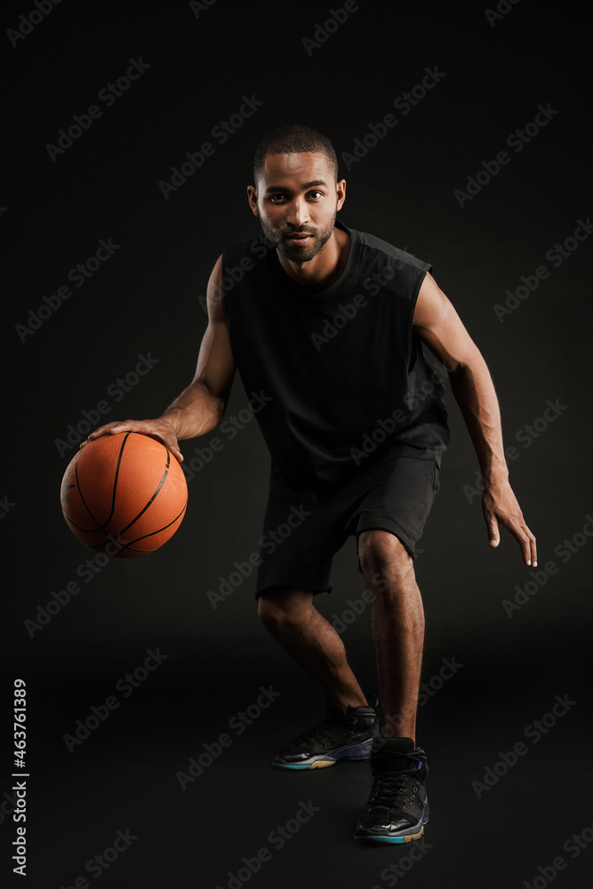 Young bristle sportsman playing basketball while working out