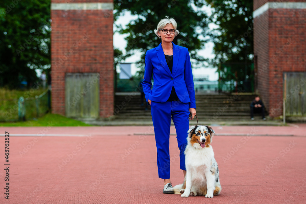 A portrait of a woman with a beautiful Australian Shepherd. A portrait of a woman with a beautiful Australian Shepherd.