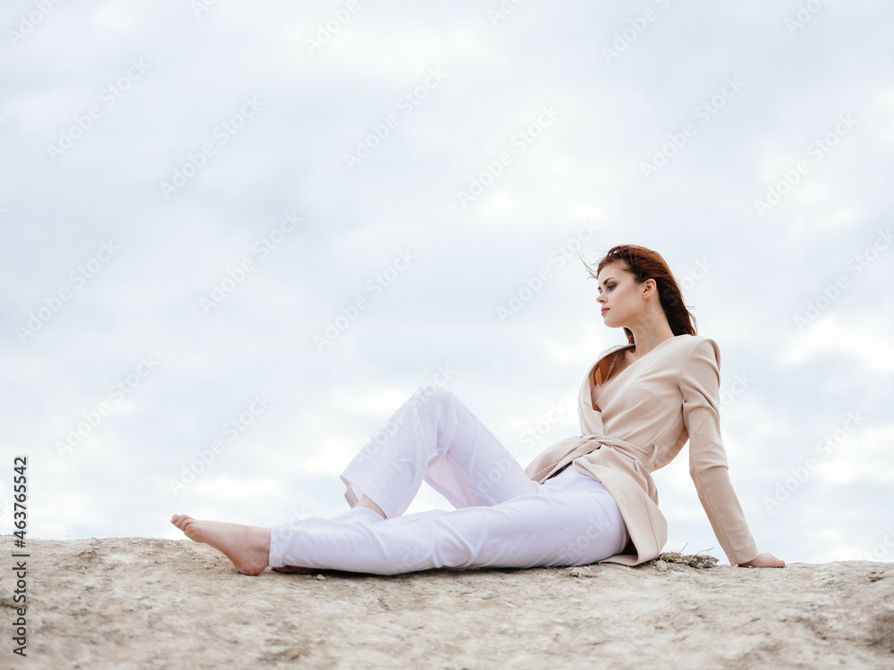 beautiful woman sitting on the sand model Travel
