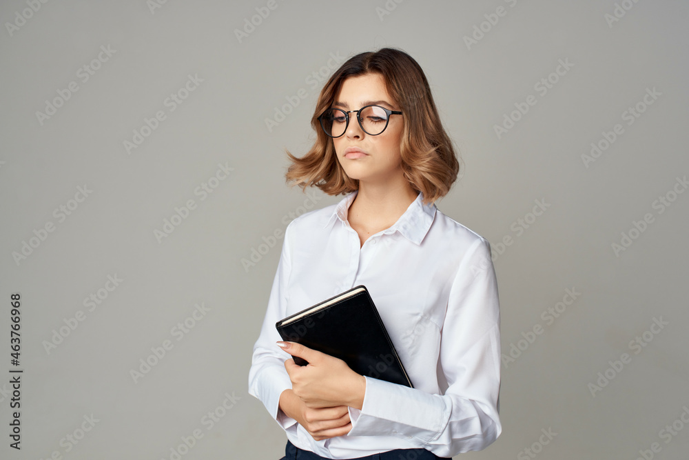 Business woman in white shirt documents office manager posing Business woman in white shirt documents office manager posing