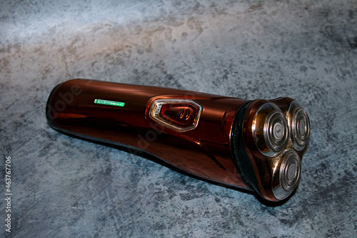 Фотография the electric razor lies on a blue background, the men's skin care razor is locat