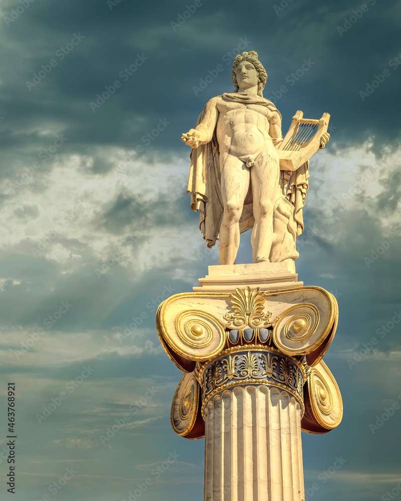 Apollo the ancient Greek god of poetry and music marble statue under dramatic sky, Athens Geece