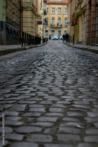 Old cobbled high street with selective focus on cobble stones