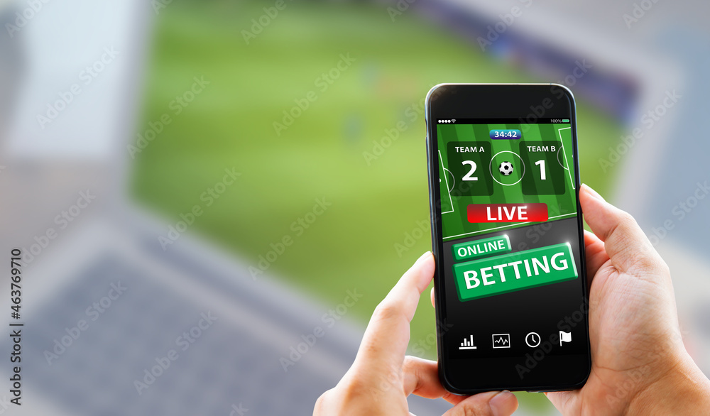 Online sports betting concept.Man hands holding mobile phone