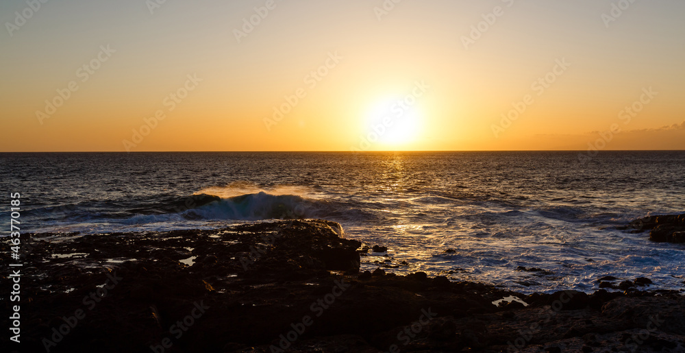 Evening scene on sea, stones, calm ocean