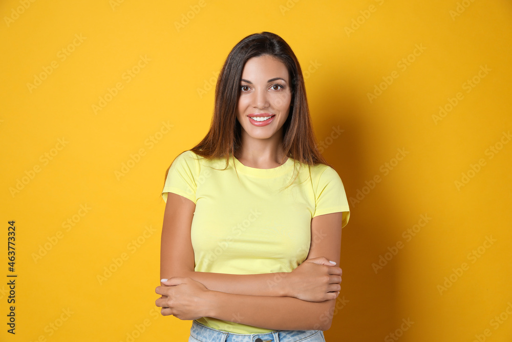 Obraz premium Portrait of beautiful woman on yellow background