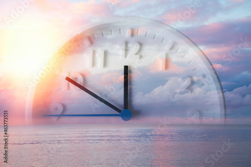 Beautiful lilac sky, ocean and close up of clock. Double exposure. Copy space. Concept of Daylight Savings Time