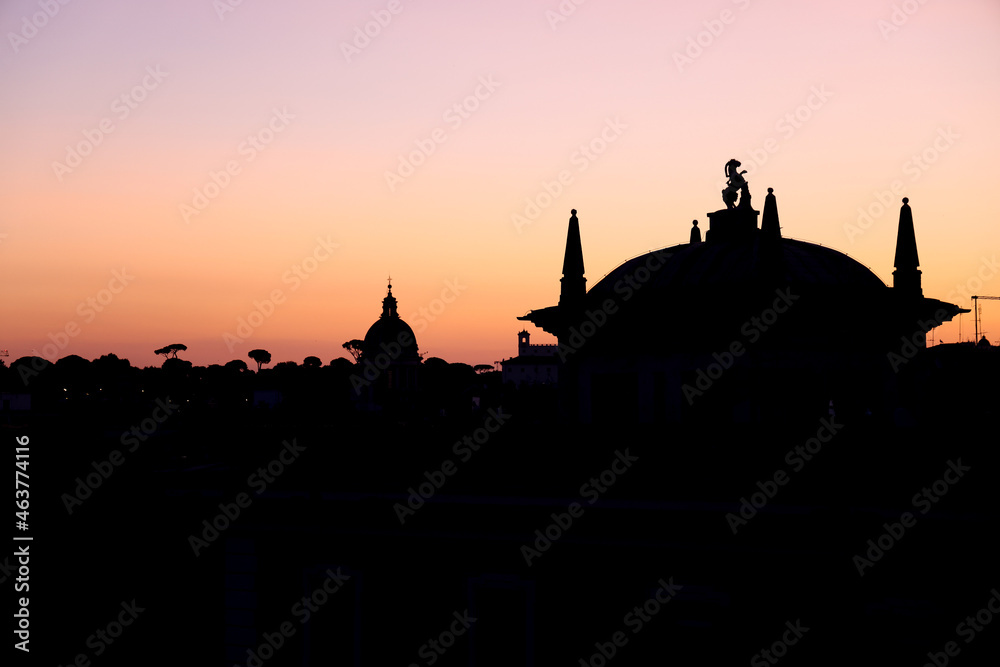 Beautiful sunrise or sunset in Rome; silhouettes city scape. Rooftop view panorama with ancient architecture in Italy and soft vanilla sky.