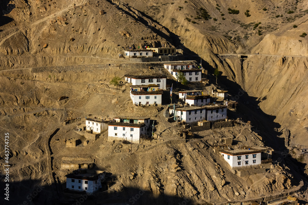 The Himalayan village of Dhankar with houses spread on a steep dry mountain slope in the Spiti valley in Himachal Pradesh, India.
