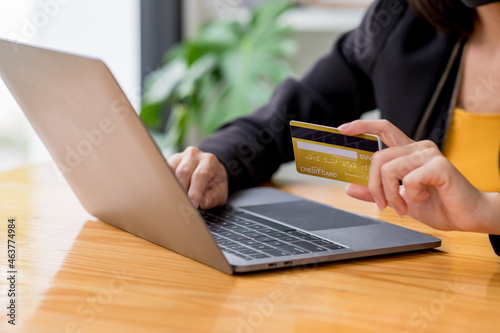 Business woman holding credit card and typing on the laptop for online shopping and payment makes a purchase on the Internet, Online payment, Business financial and technology.