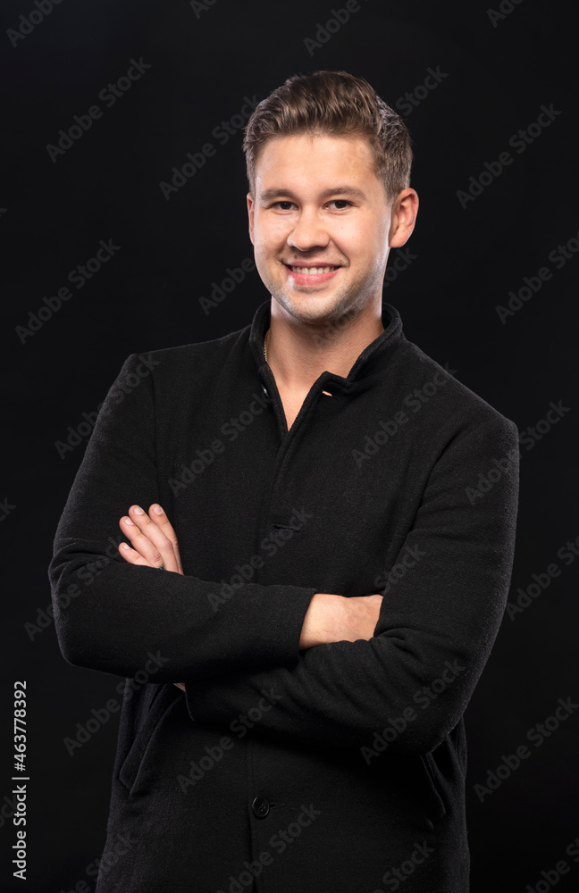 Portrait of smiling handsome man posing in studio