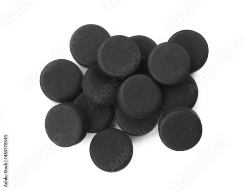 Activated charcoal pills on white background, top view. Potent sorbent photo