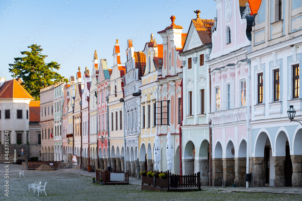 Naklejka premium Row of traditional houses in the town of Telč, Czech Republic, after the sunrise. These houses on the main square are UNESCO heritage site.