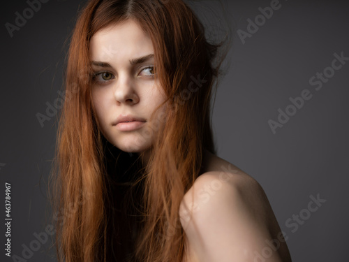 woman with naked torso and posing hairstyle fashion dark background